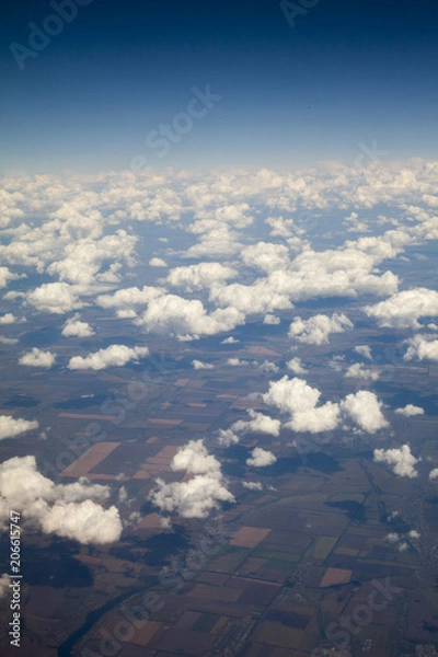 Obraz earth and clouds. the view from the plane