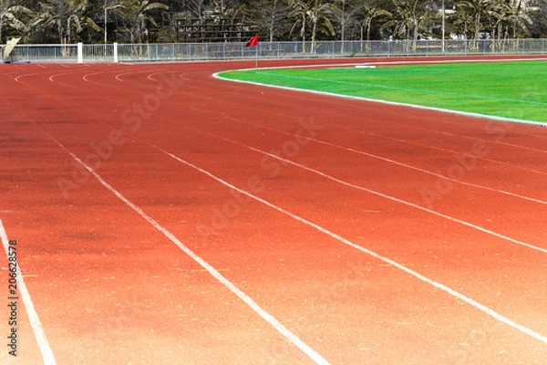 Fototapeta Red running track, white line in the stadium