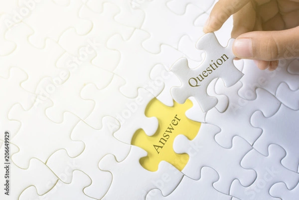 Fototapeta hand holding question and answer word on jigsaw puzzle. q&a, faq and question concept