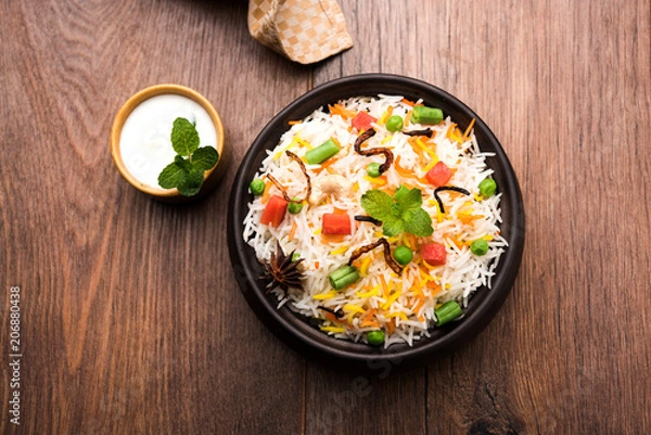 Obraz Indian Vegetable Pulav or Biryani made using Basmati Rice, served in a ceramic bowl. selective focus