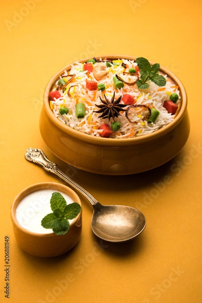 Obraz Indian Vegetable Pulav or Biryani made using Basmati Rice, served in a ceramic bowl. selective focus