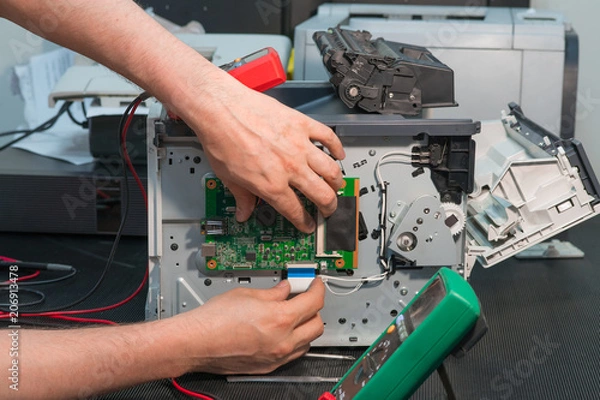Obraz Repair of laser printer, disconnection of wiring ribbon cable.