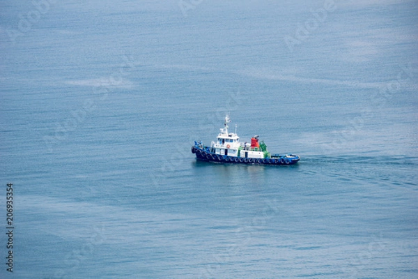 Fototapeta Tugboat is sailing in to the harbour.