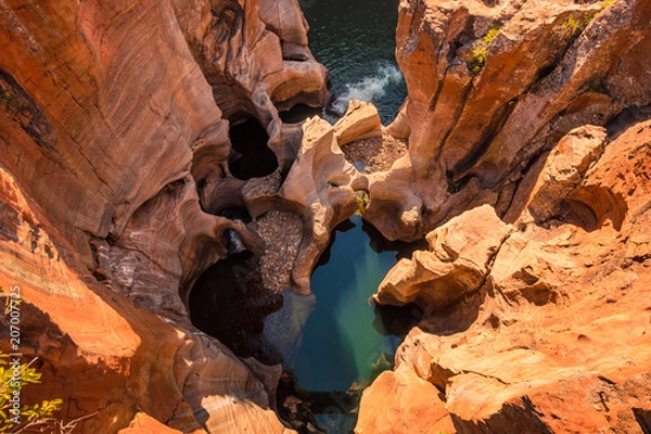 Fototapeta A view looking down on the the plunge pools at Bourke’s Luck Potholes in Mpumalanga, South Africa; a geological formation carved out by the movement of water