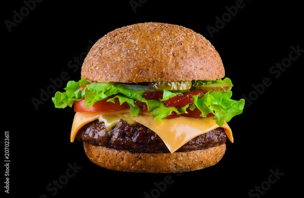 Obraz Big tasty hamburger or cheeseburger isolated on black background with grilled meat, cheese, tomato, bacon, onion. Burger closeup