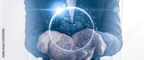 Fototapeta Businessman holding a glove with connection dots. Global corporate communication concept.