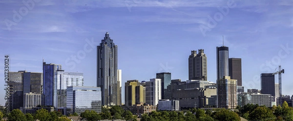 Fototapeta Downtown Atlanta Skyline showing several prominent buildings and hotels under a blue sky.