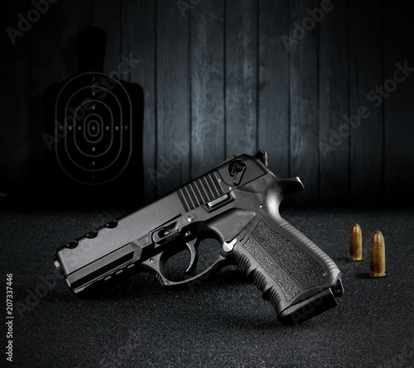 Obraz Hand Gun and Bullets atthe Shooting Range