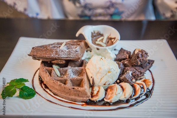 Obraz Ice cream with fruit (banana, chocolate) and a group of customers come to sit or eat. It is a menu to impress customers and return to service again.
