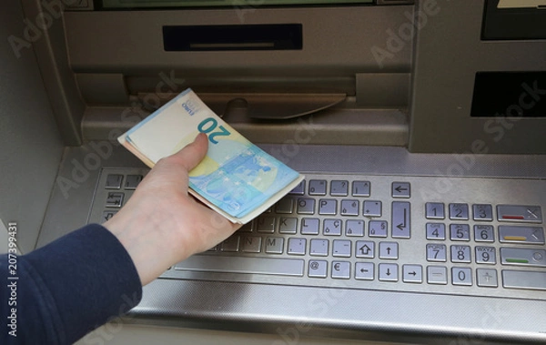 Obraz atm machine and european banknotes on the hand