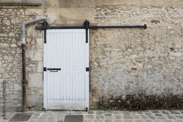 Obraz White Sliding Door against Stone Wall