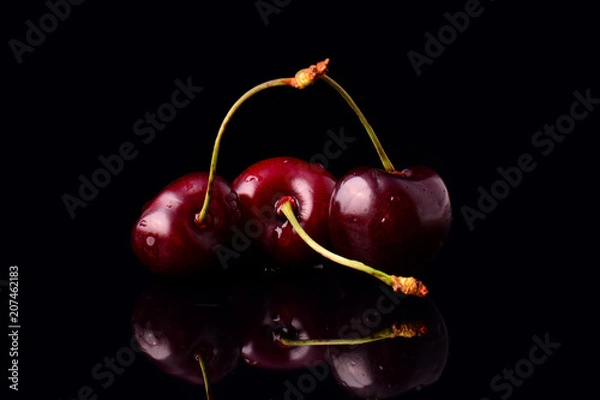 Obraz Red cherries on black background