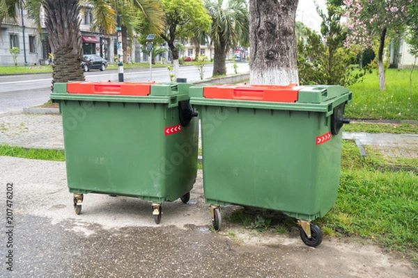 Fototapeta Big green recycling containers on the street
