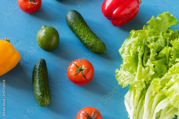Obraz Rainbow fruits and vegetables on a blue wooden table. Healthy food diet concept.