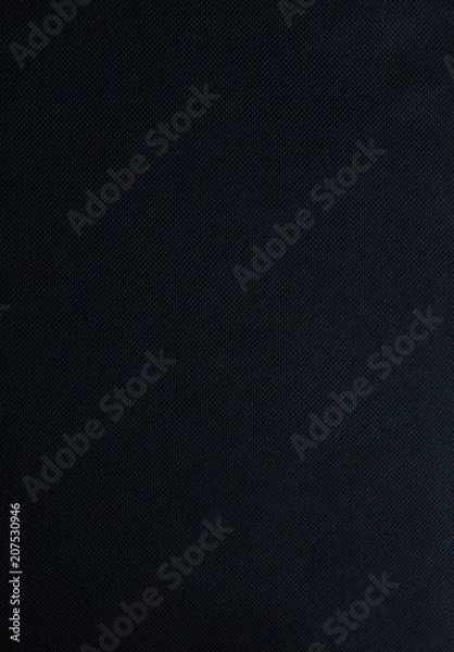 Fototapeta Black notebook is lying on wooden background. Sketch book texture. Vertical photo.