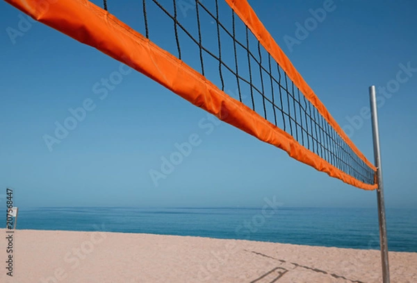 Fototapeta A beach volleyball net on the beach with a clear and sunny sky
