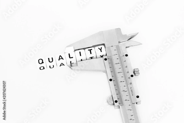Fototapeta Quality symbol with alphabet cubes and caliper