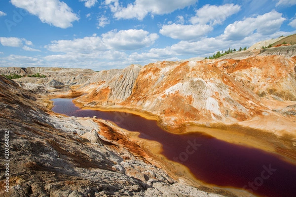Fototapeta Flooded open pit quarry ore clay mining with amazing terricons heaps scour and washouts