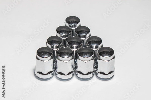 Fototapeta Car service, nut of fixture of a wheel of the car on a white background,