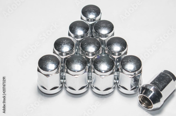 Fototapeta Car service, nut of fixture of a wheel of the car on a white background,