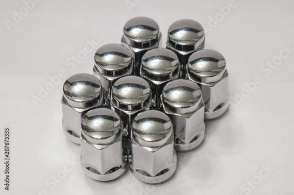 Fototapeta Car service, nut of fixture of a wheel of the car on a white background,