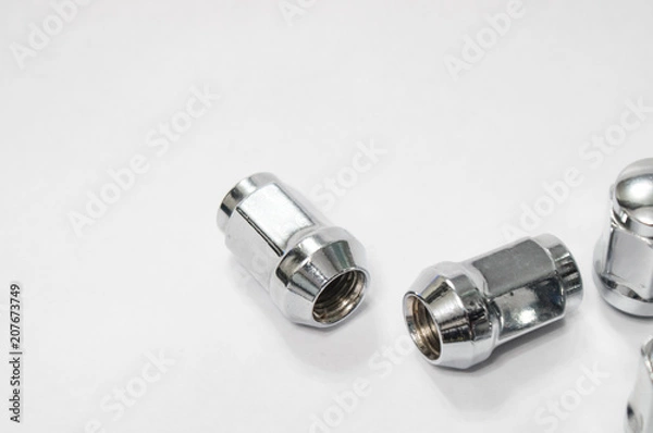 Fototapeta Car service, nut of fixture of a wheel of the car on a white background,
