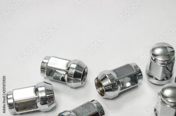Fototapeta Car service, nut of fixture of a wheel of the car on a white background,