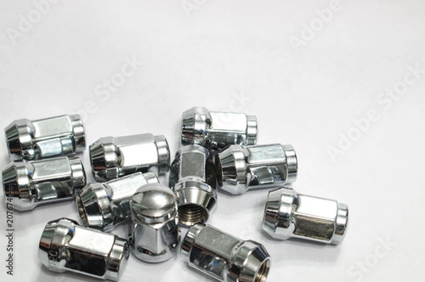 Fototapeta Car service, nut of fixture of a wheel of the car on a white background,