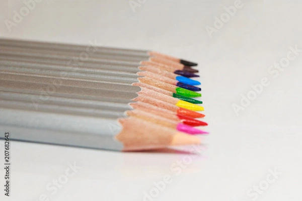 Obraz Color pencils lie in a line on white background.