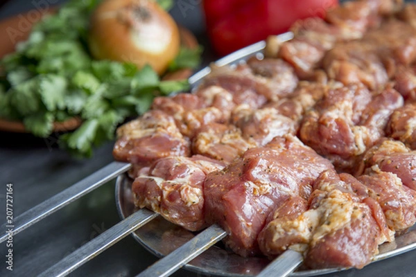 Obraz Marinated meat. Pork pieces on skewers. Sashlik on a skewers