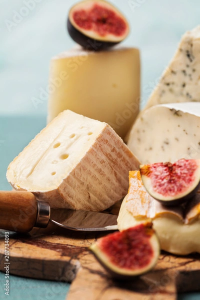 Fototapeta Variety of cheeses on serving board