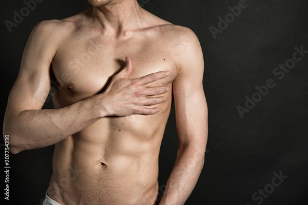 Obraz Sexy man without a shirt. Black background. 