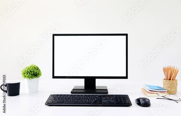 Fototapeta front view blank screen Computer with mouse, keyboard,pencils and tree vase in Modern office