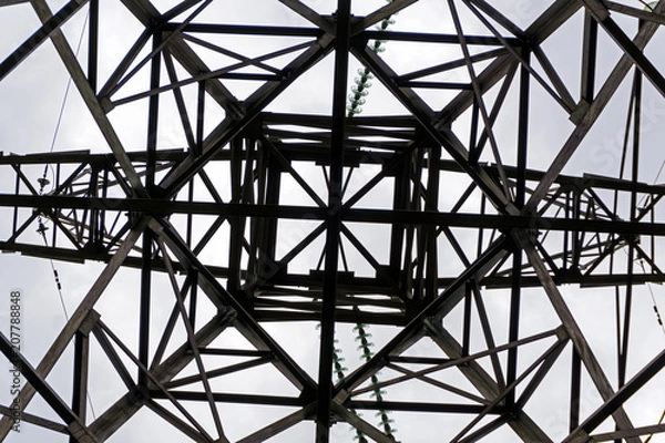 Obraz symmetrical pattern formed by a bottom view of a steel grid-shaped power line support
