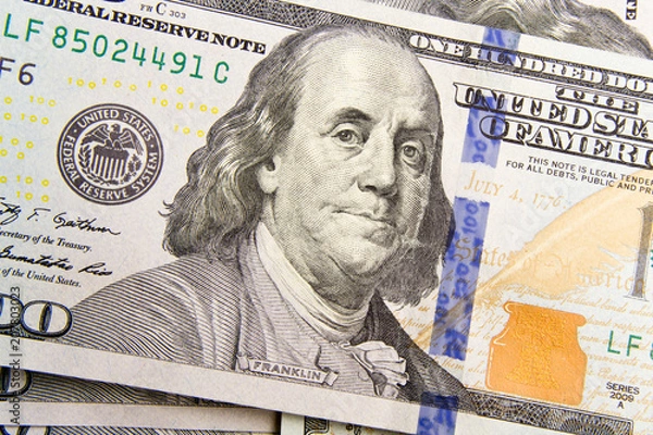 Fototapeta Front of the one hundred dollar bill with a Portrait of President Benjamin Franklin's close-up