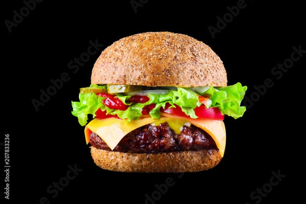 Obraz Big tasty hamburger or cheeseburger isolated on black background with grilled meat, cheese, tomato, bacon, onion. Burger closeup