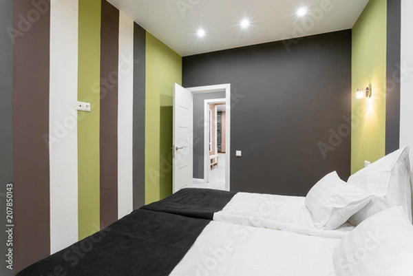 Fototapeta Hotel standart room. modern bedroom with white pillows. simple and stylish interior. interior lighting