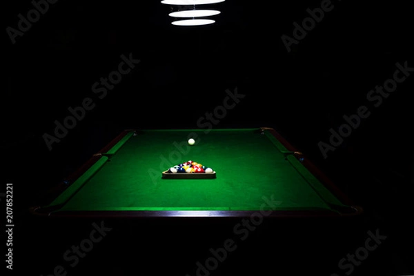 Fototapeta Game of billiards on a table with green cloth 