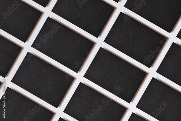 Obraz Photo of blank textured business cards on white. Mock-up for branding identity. For graphic designers presentations and portfolios. Business cards stacks arranged in rows at white paper background.
