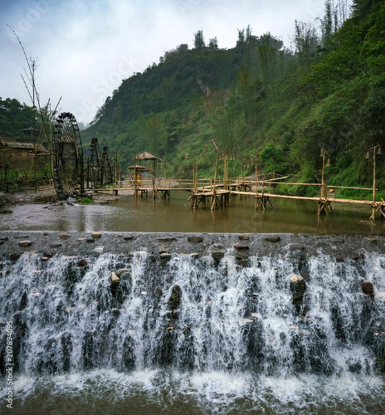 Obraz Bamboo bridge behind a waterfall