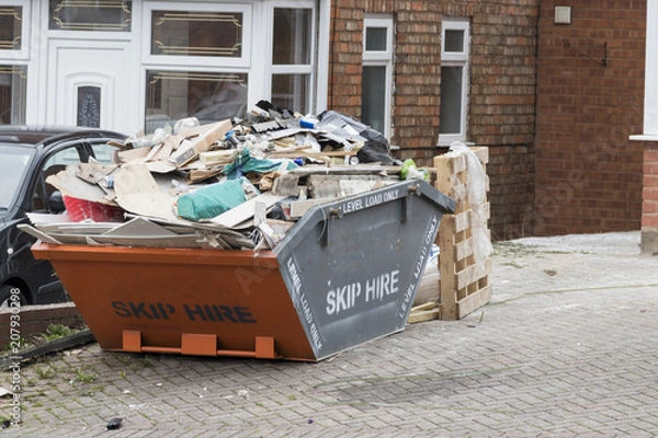 Fototapeta Street side skip filled with rubish