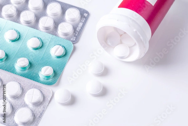 Obraz Pills from bottle on the white background