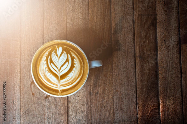 Obraz A white cup of coffee latte or cappuccino art on wood table