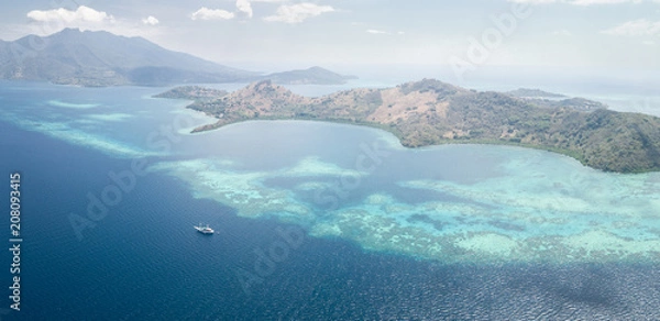 Fototapeta Aerial View of Ship, Coral Reef, and Islands Near Flores