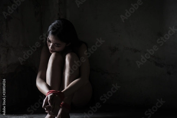 Fototapeta Victims of abducted women get wrists and feet in red. You have no way to fight or resist. She needs help. Hostage concept or female kidnapped from robber. Copy space. Dark Concepcion.