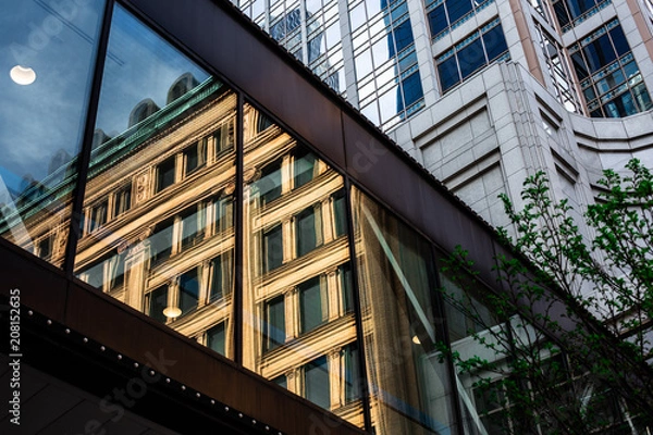 Fototapeta Close cropped image of building's reflection in skywalk window