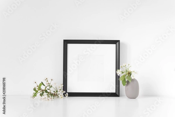 Fototapeta Black square frame mockup with spring cherry bouquet. Mock up for your photo, design or text. Background