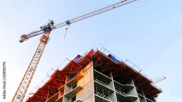 Obraz Consrtuction crane near building. Construction site.