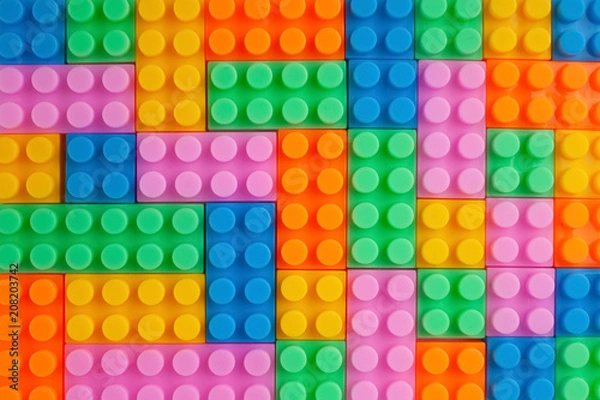 Fototapeta Colourful plastic construction blocks. Top view