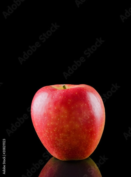 Fototapeta Red apple on a black background with reflection / Red apple on a black background